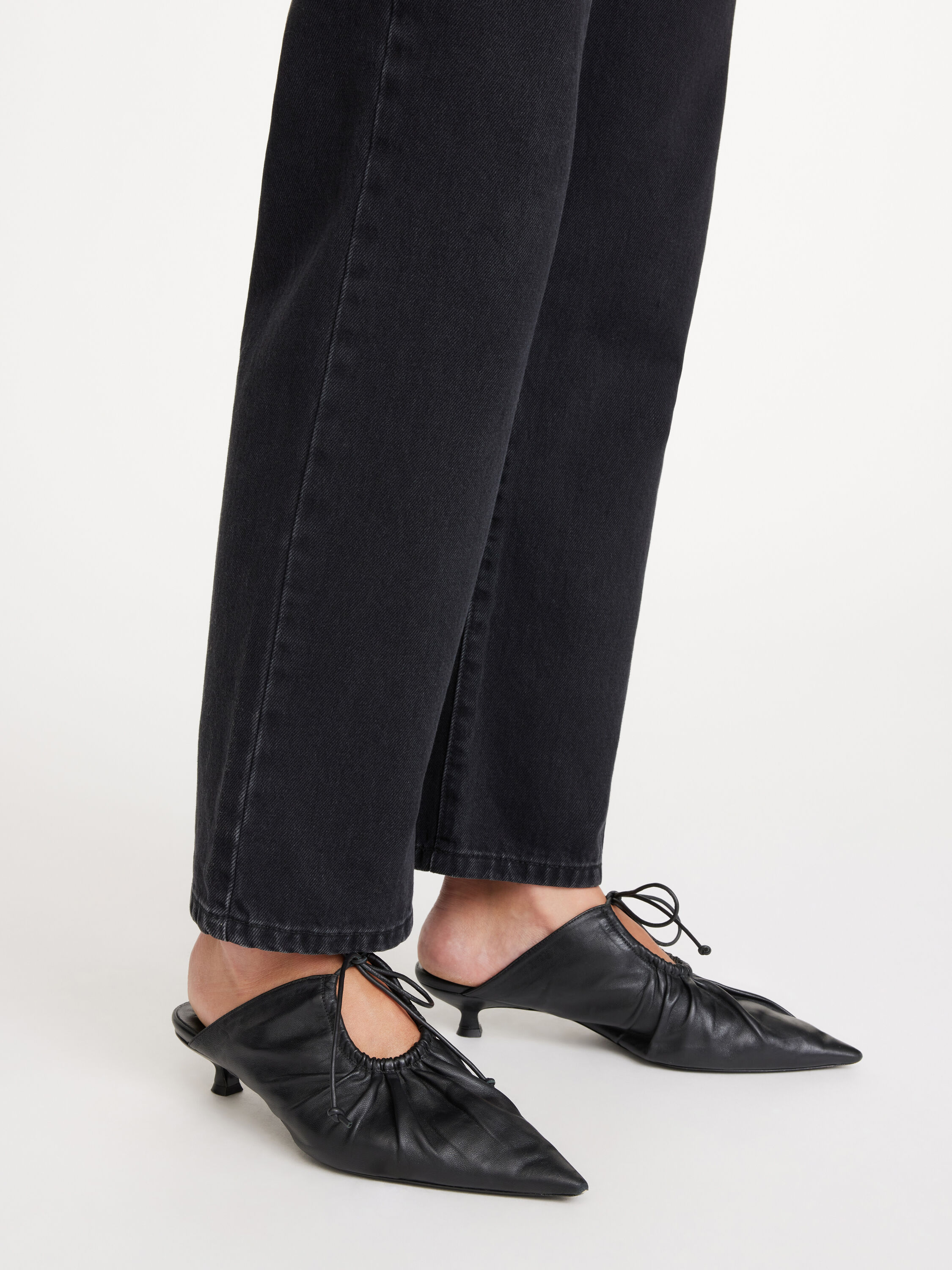 Black leather store mules